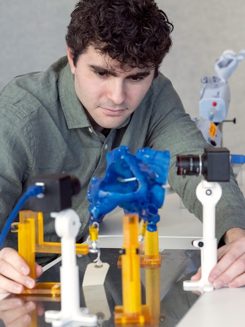 Matthew Daemer, lead cardiac modeling technician in the Jolley Lab, simulates placement of a “clip” used to repair mitral valve regurgitation in a 3D-printed model of a patient’s heart.