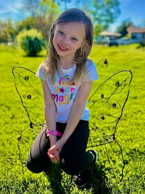 Cassidy in butterfly chair outside