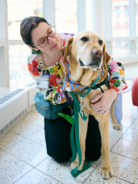 CHOP child life specialist Lizzy Olsen with her facility dog, Dilly.