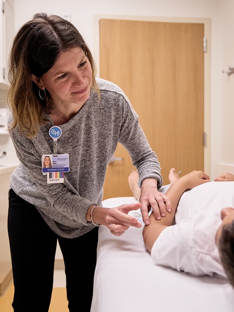 Patient with clinician doing acupuncture