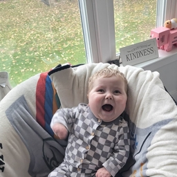 New born baby is laughing.