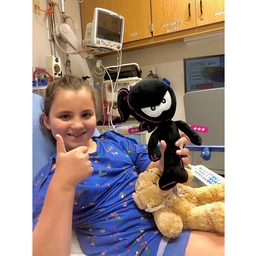 Lillian in the hospital, thumbs up!