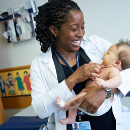 Female physician with baby