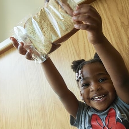 Child holding a sandwich Child holding a sandwich