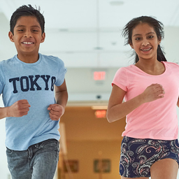 Young boy and girl running down hall Young boy and girl running down hall