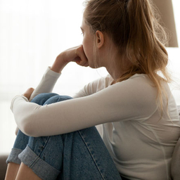 Recognizing Depression in Your Child or Teen young depressed teen siting in couch looking out window