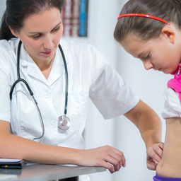 Doctor examining a child's stomach Doctor examining a child's stomach
