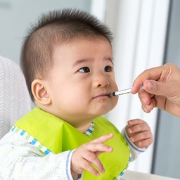 Young baby taking oral injection medicine Young baby taking oral injection medicine