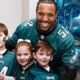 Najee Goode poses with kids at the 8th annual Huddle Up for Autism Najee Goode poses with kids at the 8th annual Huddle Up for Autism