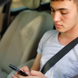 Teen driver looking at phone Teen driver looking at phone
