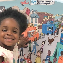 CHOP patient in front of mural CHOP patient in front of mural