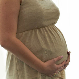 Mother holding pregnant stomach Mother holding pregnant stomach