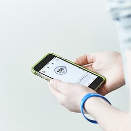 Teen using mobile app to monitor glucose level Teen using mobile app to monitor glucose level