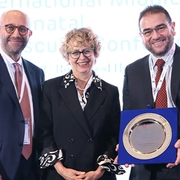 People holding an award People holding an award