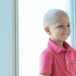 Thomas in hospital window smiling Young boy cancer patient sitting in hospital window smiling