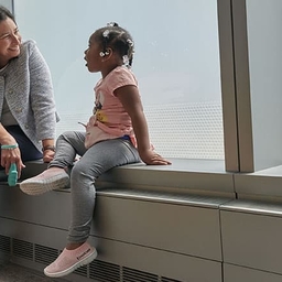 Doctor talking to child next to window Doctor talking to child next to window