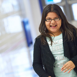 Young girl in hallway smiling Young girl in hallway smiling