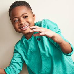 Zion holding a football Zion holding a football