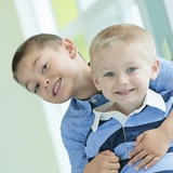 Older brother hugging his younger brother