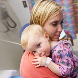Mother holding her child tight in a comforting hug