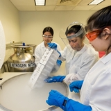 Doctor and interns in research lab extract patient-based cell lines and samples from liquid nitrogen