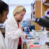 Physician working in the lab with her colleague.