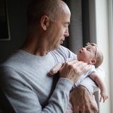 Grandfather holding a newborn 