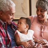 Grandparents holding grandchild
