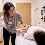 Patient with clinician doing acupuncture
