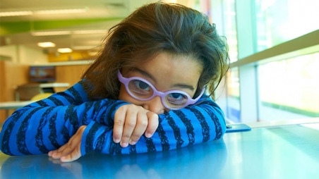 Shy young girl with glasses