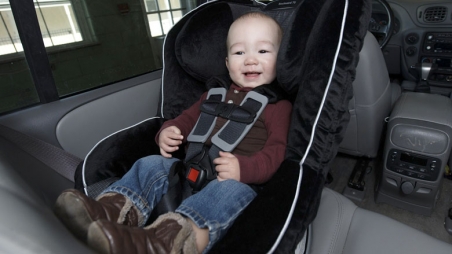 Smiling baby in rear facing car seat