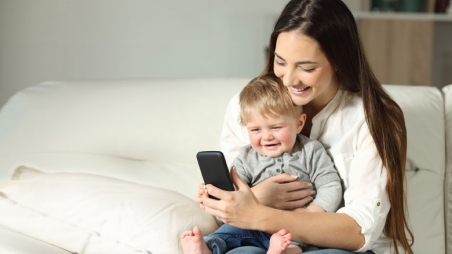 mom and baby using phone for telehealth