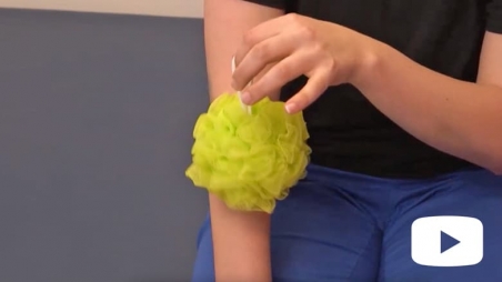 Person rubbing their arm with a sponge