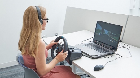 Teen using mobile driving simulator
