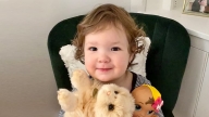 June holding her stuffed animals