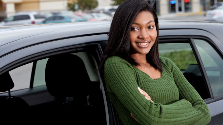 teen girl leaning against car