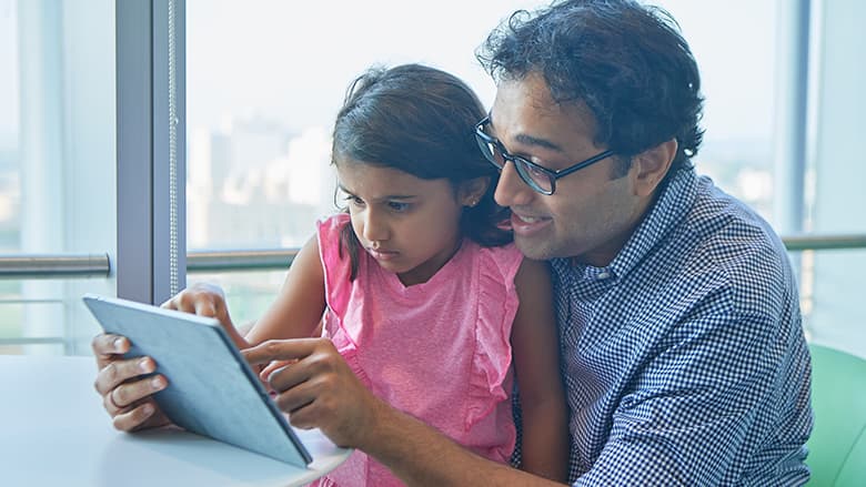 Father and daughter doing video checkup on tablet