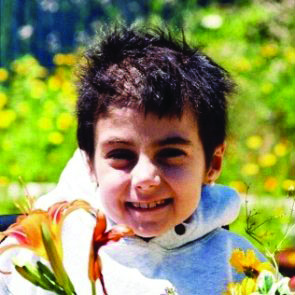 closeup of young girl cancer patient smiling outside