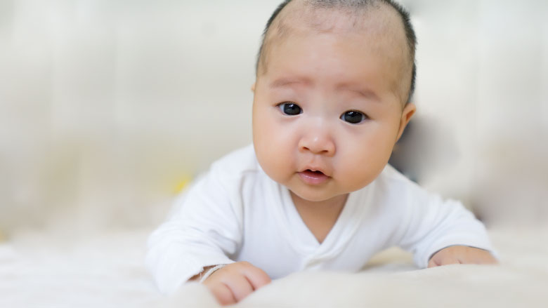 baby laying on stomach tummy time