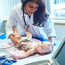 Doctor with baby getting an ECG