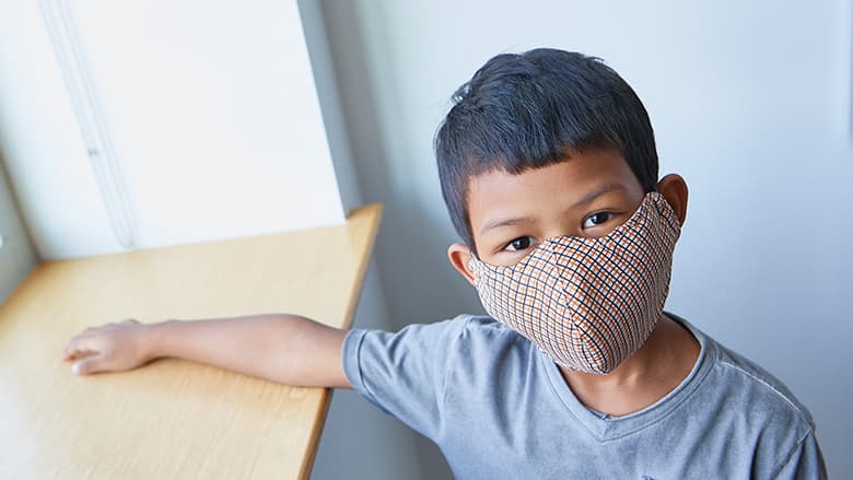Young boy wearing protective face mask