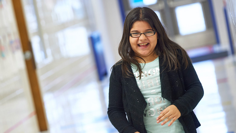 Young girl in hallway smiling